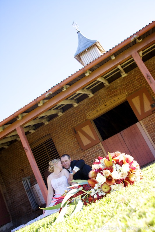 Bride and groom in front of stables - wedding photography sydney